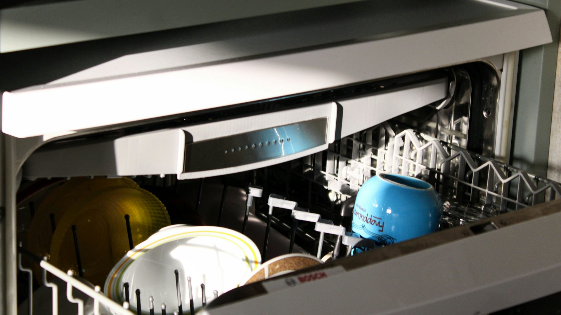 An open dishwasher in a kitchen