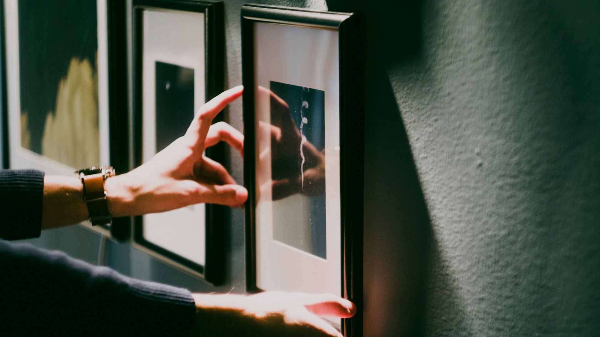 Straightening a framed picture on a wall